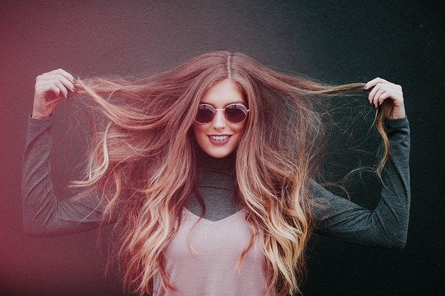 Home Remedies For Dry And Damaged Hair - Girl In Sunglasses Holding Up Hair